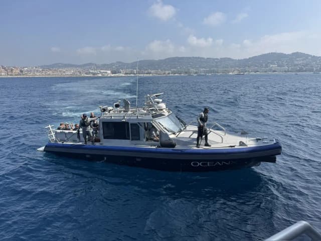 An OceanX tender boat with crew on board